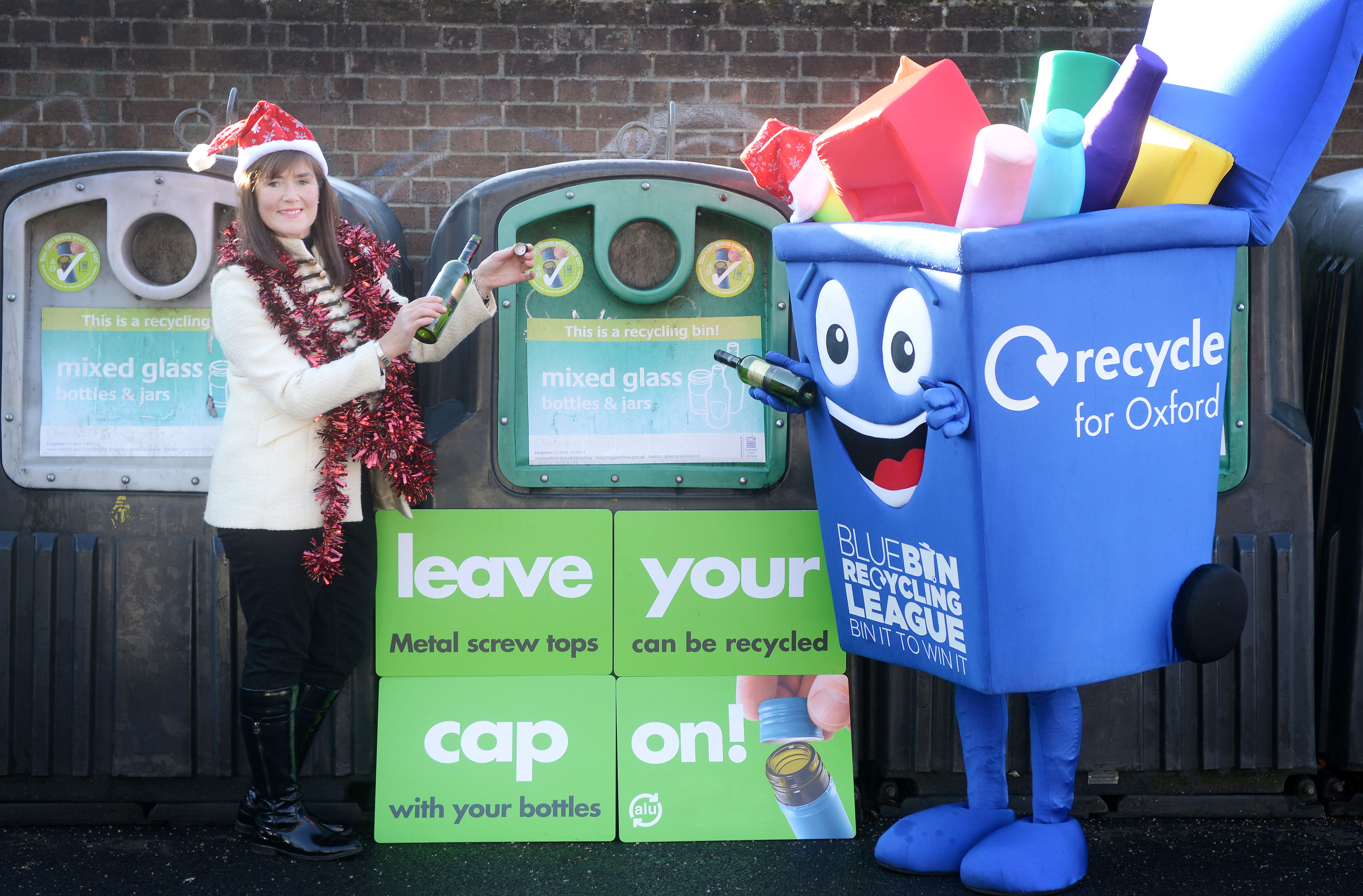 A campaign is asking residents to leave their metal bottle tops on their glss bottles/jars when recycling them in the glass recycling banks. Representatives from the council and Alupro at Tesco Oxford. Pictured at Tesco, Cowley Road, Ruth Meeke from Alupro is joined by the council recycling mascot at the bottle banks. Copyright Richard Cave 301.12.16